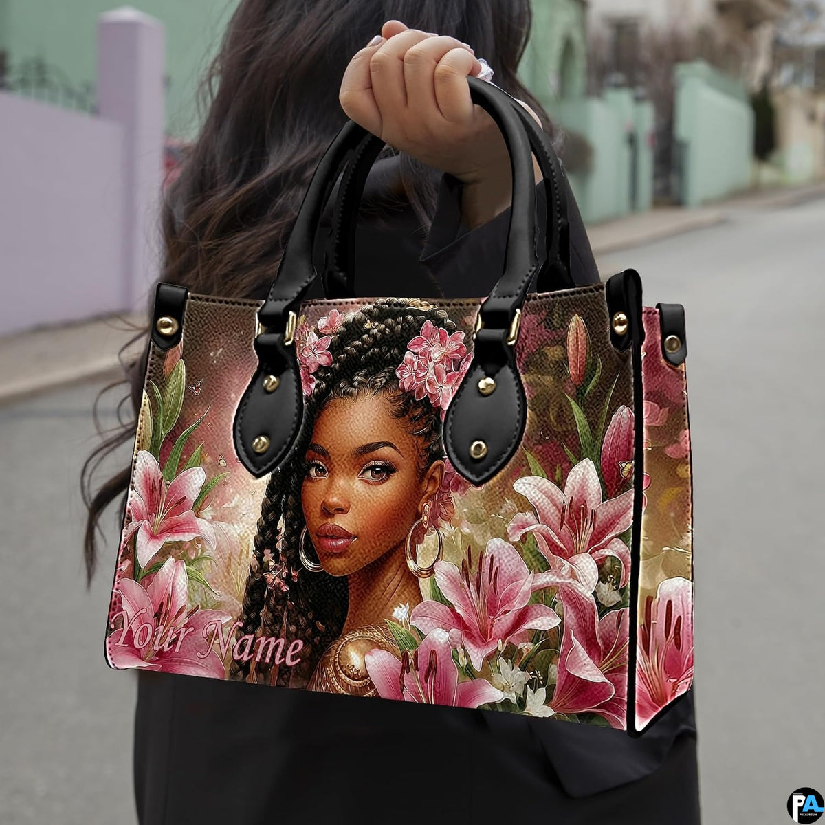 Outdoor street lifestyle display of the pink lily portrait accessory held by dual handles.