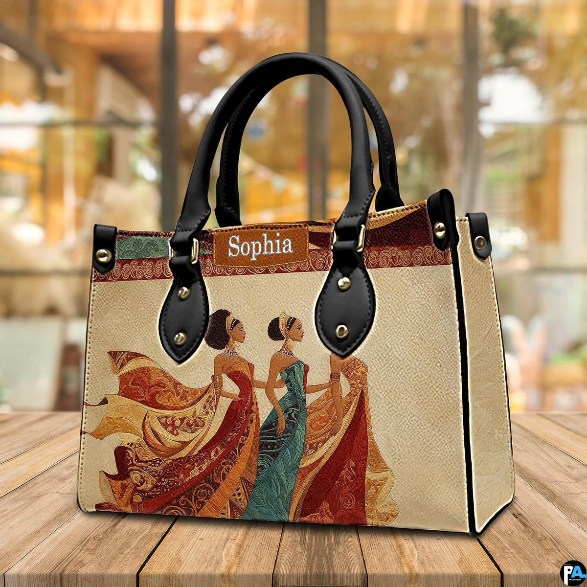 Angled cafe view of the structured African queen handbag resting on a polished wooden surface.