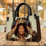 Lifestyle view of crowned natural hair portrait handbag with abundant gold jewelry