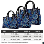 Coordinated arrangement of sapphire butterfly handbag and wallet displaying unified floral design.