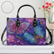 Side perspective of purple crystal butterfly handbag showing structured shape