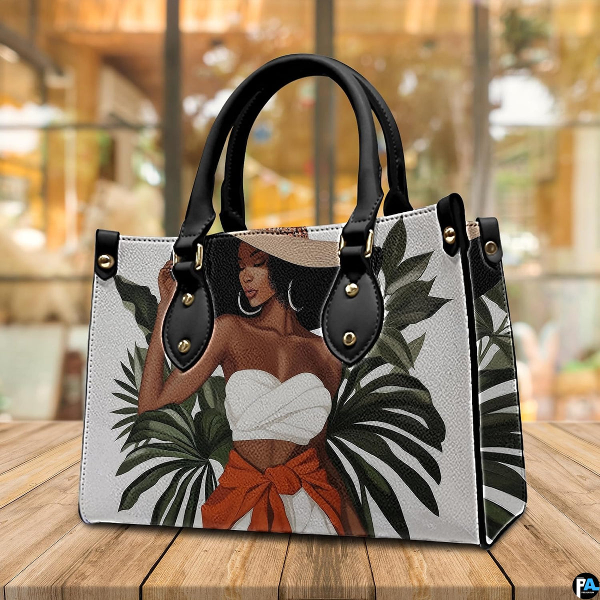 Tropical fashion art accessory resting upright on a natural timber tabletop within a warm café setting.