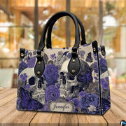 Violet skull handbag displayed on wooden plank table before indoor window.