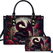 Studio front view of handbag and matching wallet with crimson dragon and red rose garden artwork.