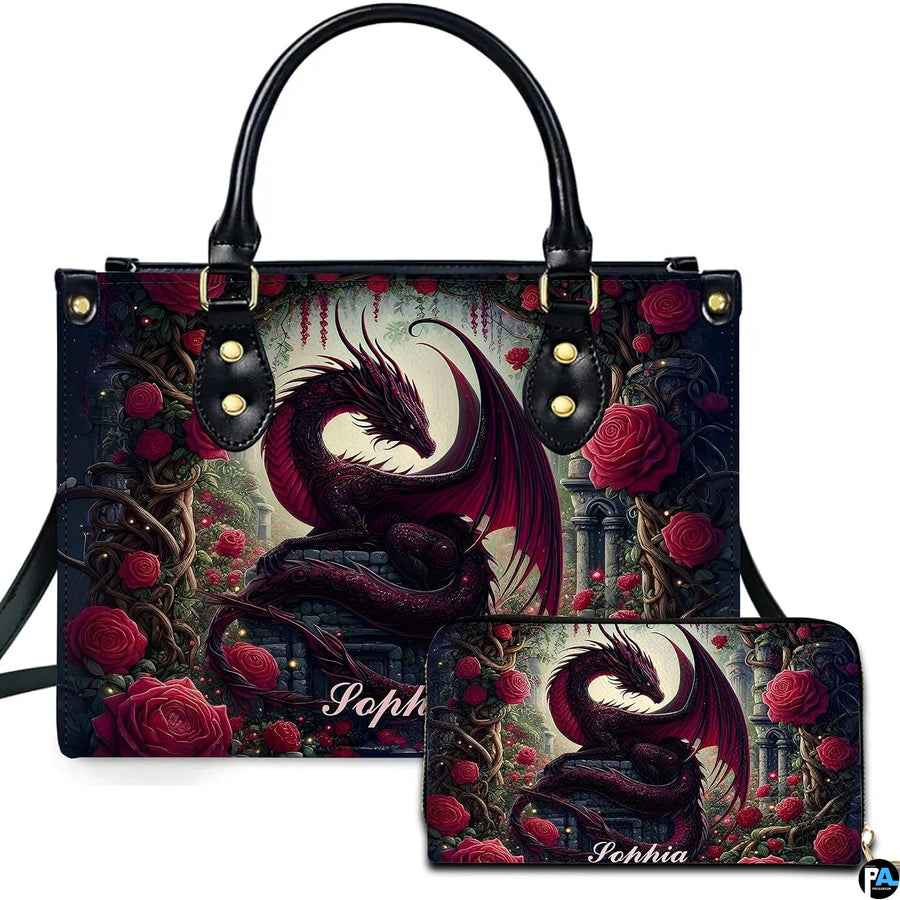 Studio front view of handbag and matching wallet with crimson dragon and red rose garden artwork.