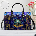 Celestial Maiden Satchel Handbag resting on white surface beside floral vase with circular texture inset.