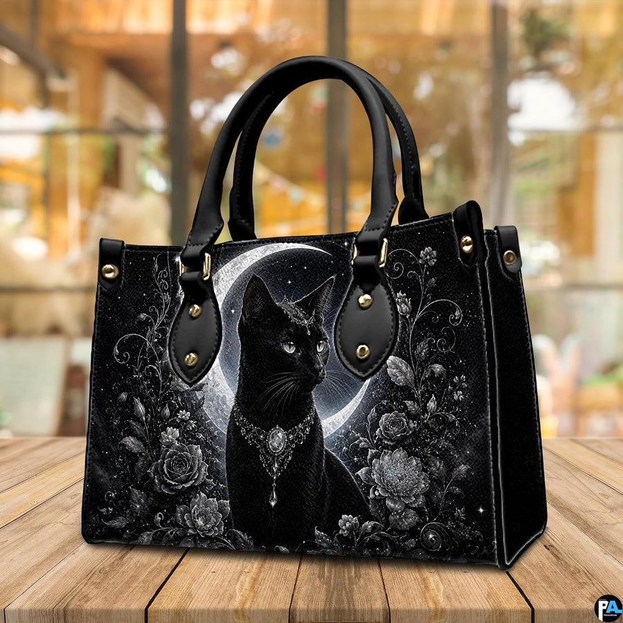 Cafe table arrangement presenting crowned black cat artwork beside sunlit window.