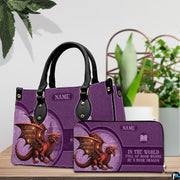 Fantasy book dragon violet handbag and matching wallet set displayed on wooden table.