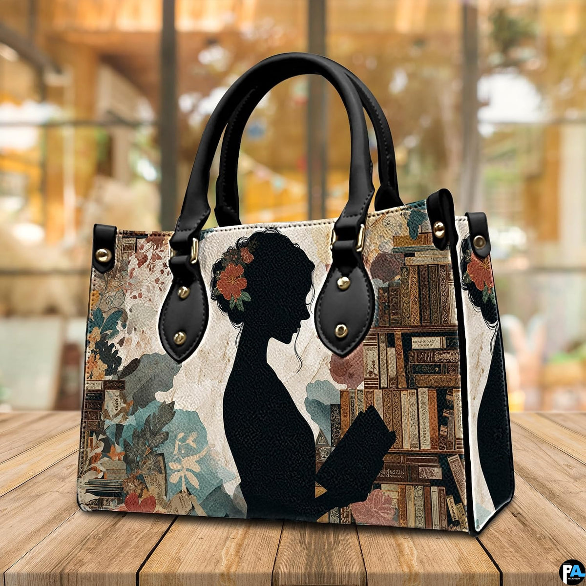 Model carrying the reading silhouette handbag outdoors displaying the artistic literary artwork.