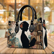 Model carrying the reading silhouette handbag outdoors displaying the artistic literary artwork.
