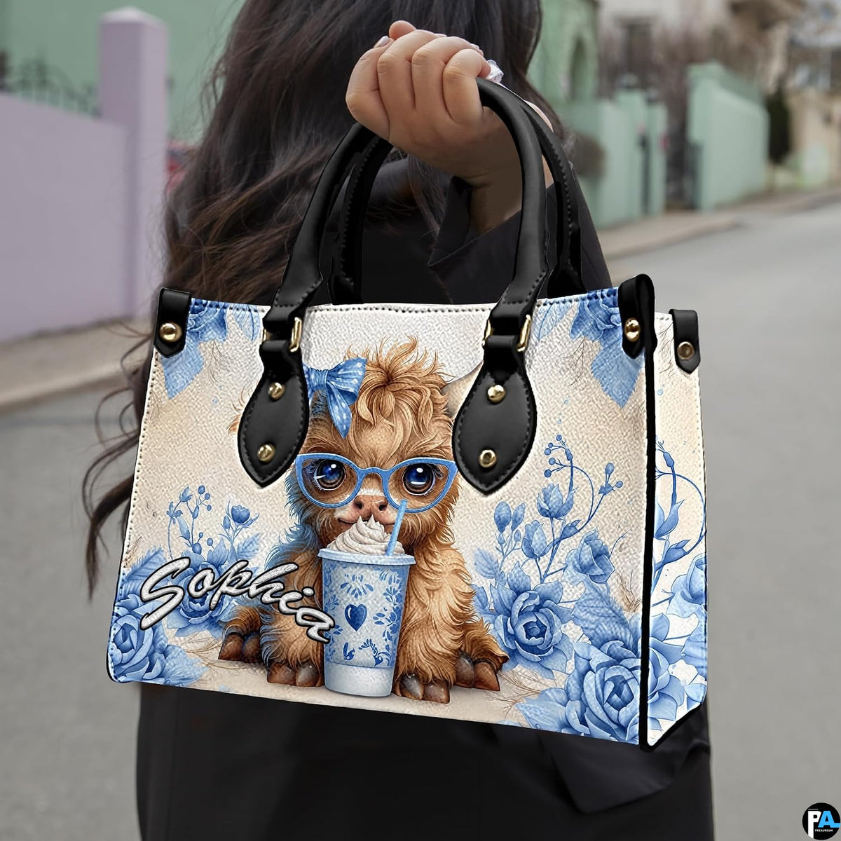 Outdoor street perspective displaying illustrated companion accessory carried by model in black outerwear