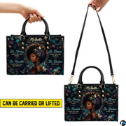 Two carrying views of teal butterfly portrait handbag