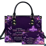 Front view of radiant purple cross handbag and matching wallet with glowing cross, florals, and butterflies.