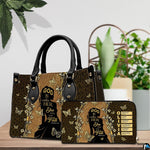 Lifestyle display of faith silhouette handbag carried over the arm in an outdoor setting.