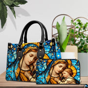 Matching handbag and zippered wallet set displayed together with stained glass art.