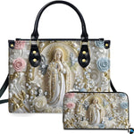 Front view of pearl framed Virgin Mary handbag and matching wallet set with pastel blue and pink roses