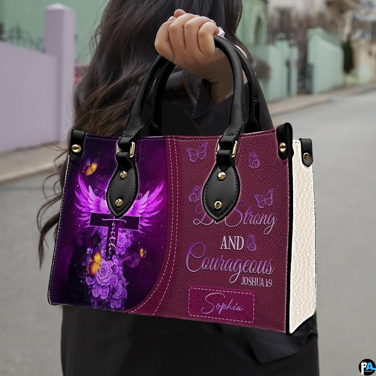 Outdoor presentation demonstrating the purple devotional cross handbag carried by a model.
