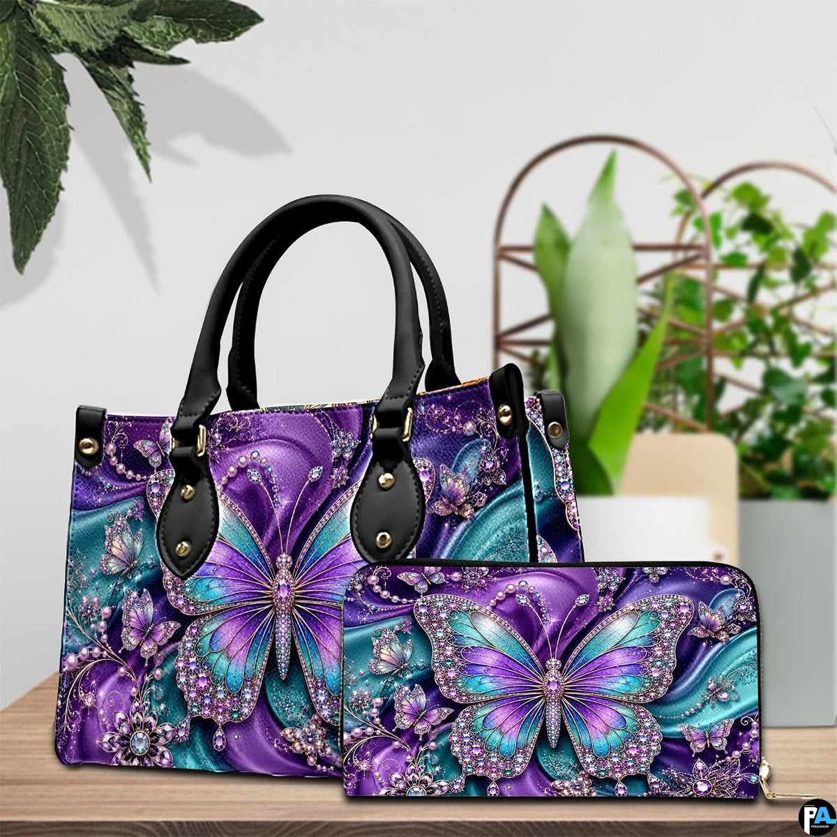 Lifestyle tabletop view showing purple and teal butterfly artwork placed beside decorative indoor house plants.