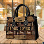 Three-quarter perspective view of vintage library handbag on a rustic wooden table.