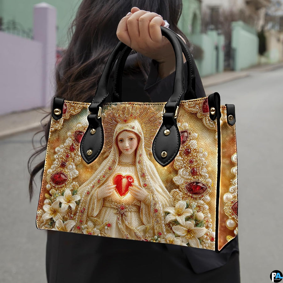 Model wearing Our Lady of Fatima handbag over shoulder with attached strap.