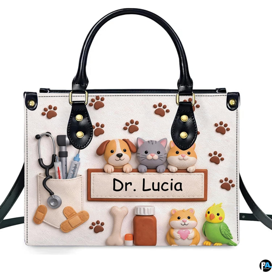Front view of veterinary handbag featuring sculpted clay pets, stethoscope, medicine bottle, and paw prints