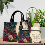 Detailed perspective of teal damask pattern with golden scrollwork and monarch butterflies on handbag.