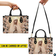 Graphic demonstrating top handle hand carrying and shoulder strap wear options for the handbag.
