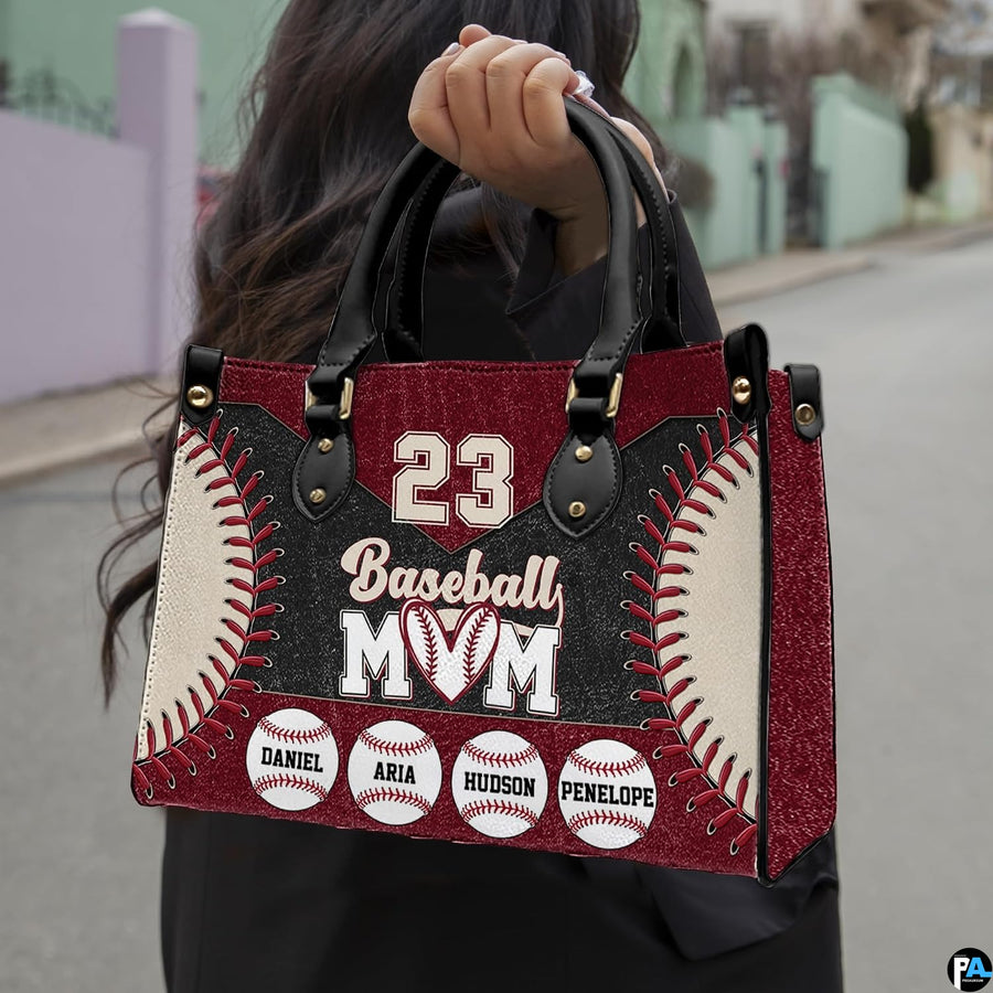 Front view of baseball handbag featuring bold curved red laces and maroon athletic panels.