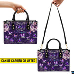 Top-down view of purple handbag showing dual handles and interior storage opening.