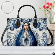 Praying Virgin Mary handbag beside floral vase with circular texture detail.