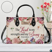 Scripture floral dragonfly handbag displayed on white table beside floral bouquet.