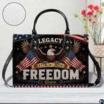 Close-up front view of handbag showing bald eagle, dual waving flags, and stars