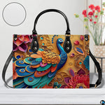 Blue peacock floral handbag with long black carrying strap
