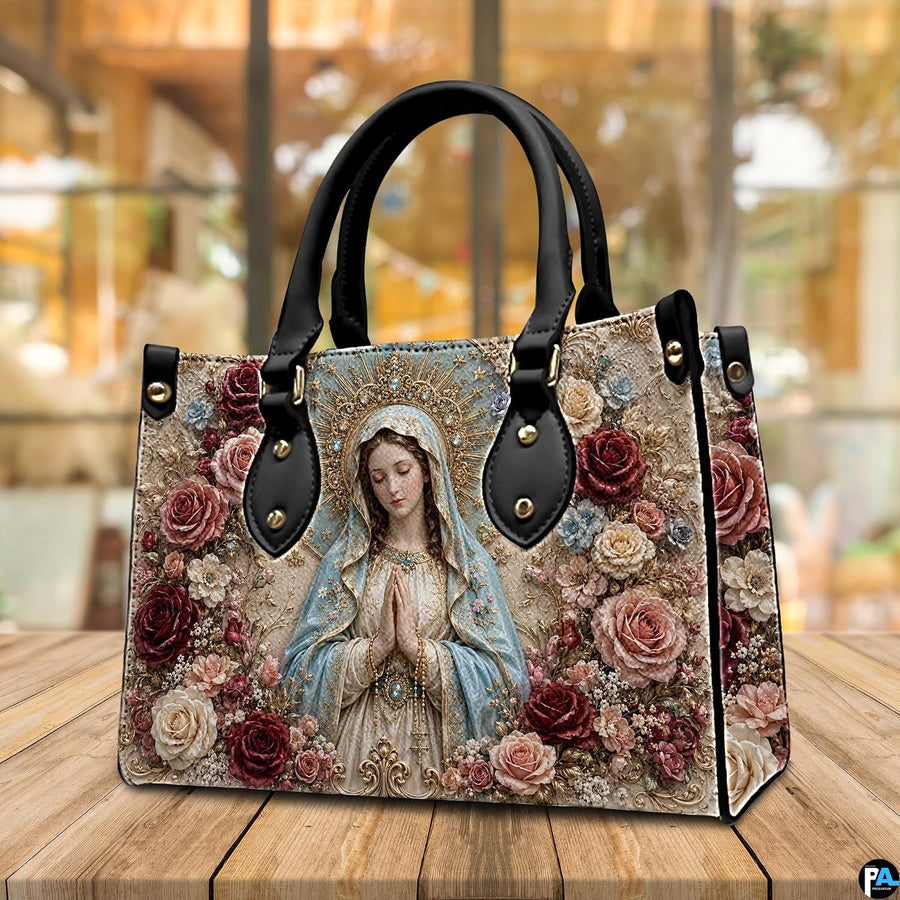 Baroque crowned Virgin Mary handbag resting on wooden table in sunlit indoor space