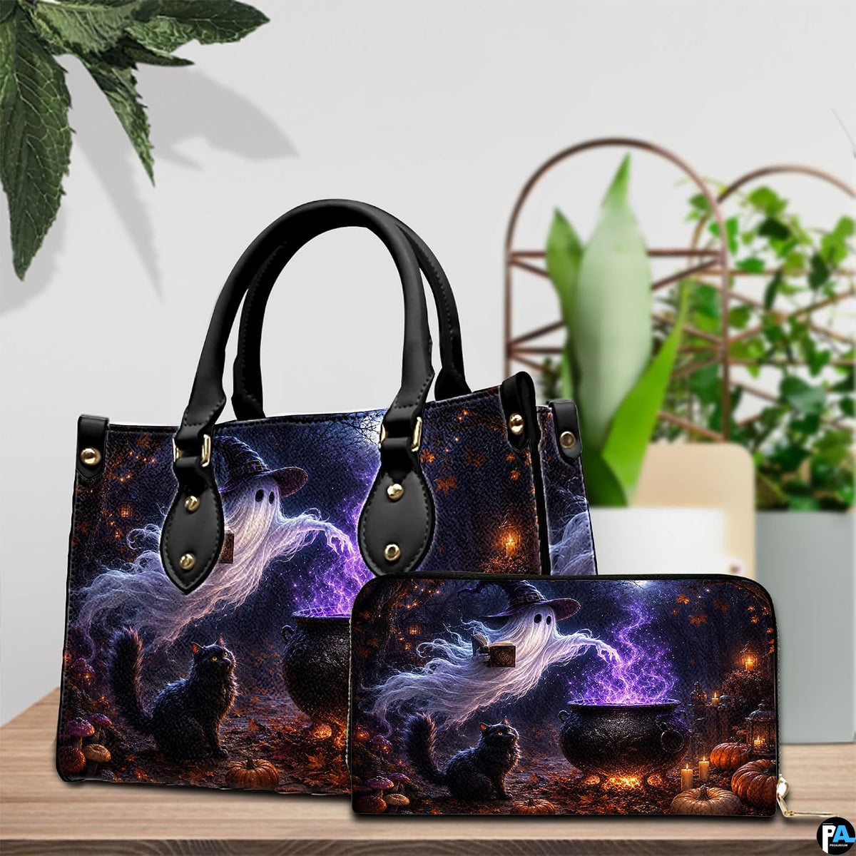 Tabletop scene showing halloween ghost art accessory resting beside indoor decorative plant.