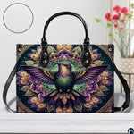 Handbag displayed in indoor setting with floral arrangement and circular texture close-up inset.