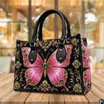 Atmospheric view of pink jeweled butterfly artwork resting on wooden surface in ambient café setting.