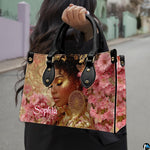 Outdoor view showing model carrying golden glow afro art accessory by top handle in natural light.