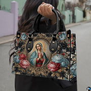 Model wearing Baroque Virgin Mary handbag over shoulder with attached strap.