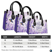 Coordinated lavender floral handbag and matching wallet set on white surface