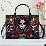 Sugar skull handbag displayed on white table beside floral bouquet.