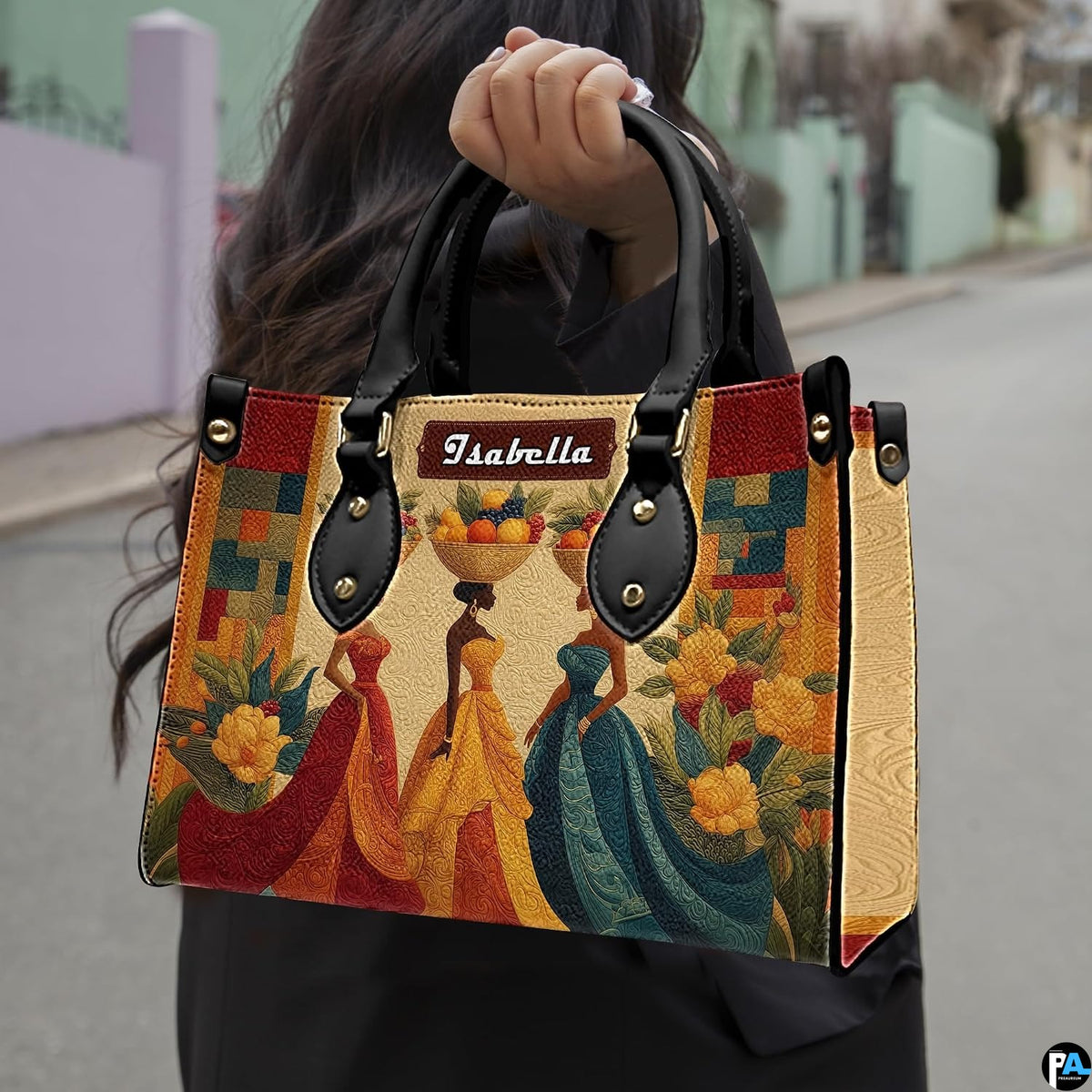 Angled side perspective displaying African harvest women artwork on structured handbag with dark handles.