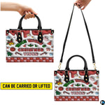 Demonstration of handbag carrying methods showing both top handle hand carry and shoulder strap wear.