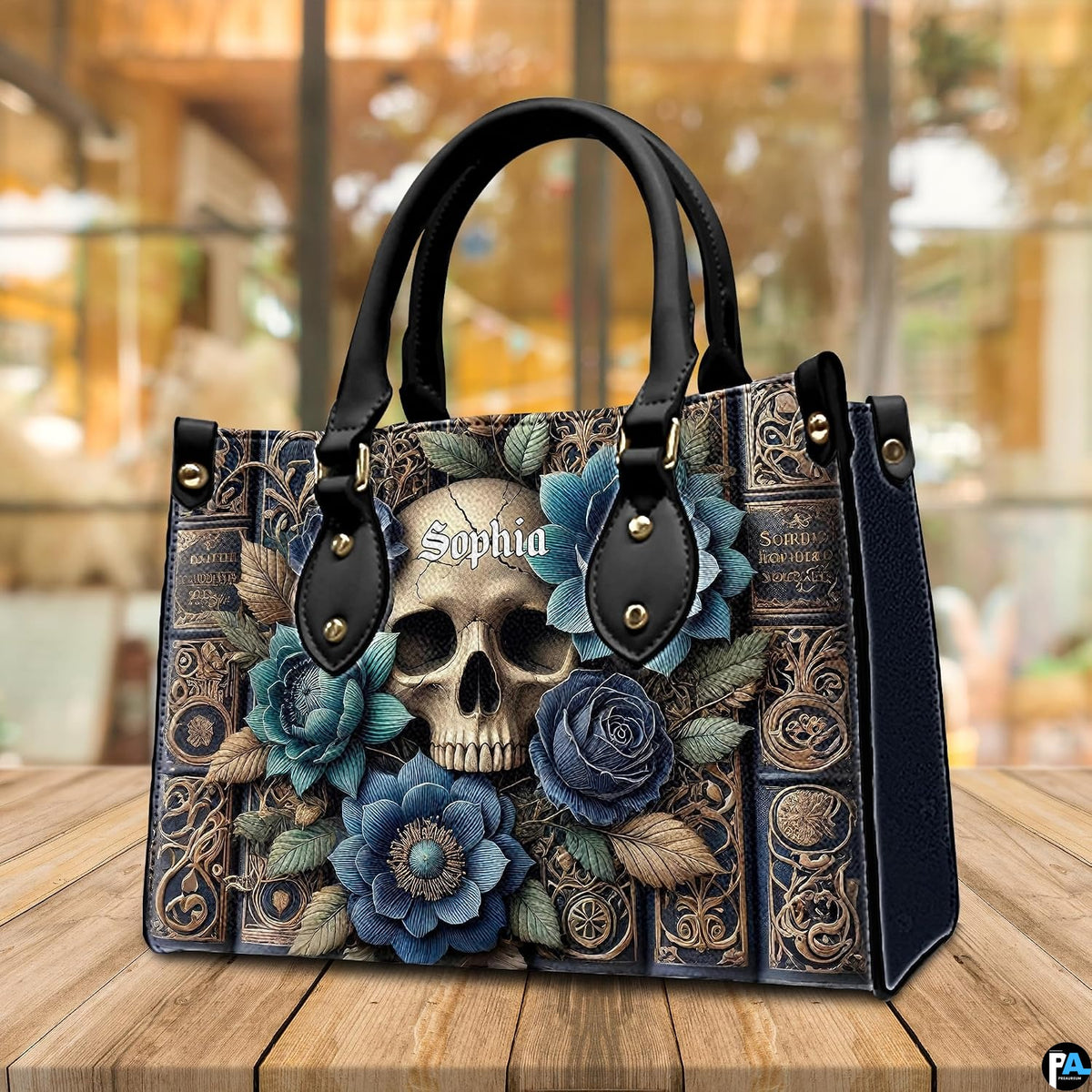 Perspective angle of gothic skull handbag highlighting book spine artwork on wooden surface.