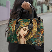 Model wearing Byzantine mosaic handbag over shoulder with attached strap.
