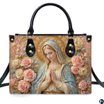 Top view of praying Madonna handbag displaying top zipper opening and carry handles