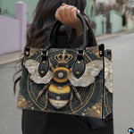 Matching zip wallet featuring the crowned bumblebee graphic and black marble backdrop.