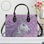 Angle perspective view of the unicorn handbag showcasing side depth and printed graphic.