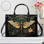 Interior view of gold dragonfly handbag showing open storage compartment with fabric lining