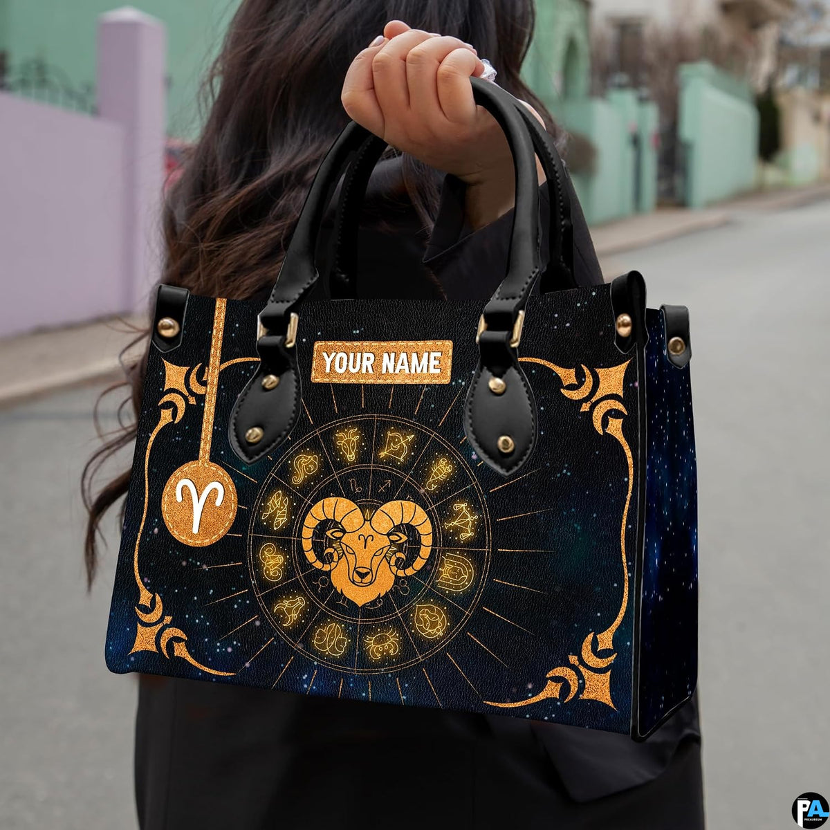 Side profile view of structured golden celestial zodiac ram handbag.